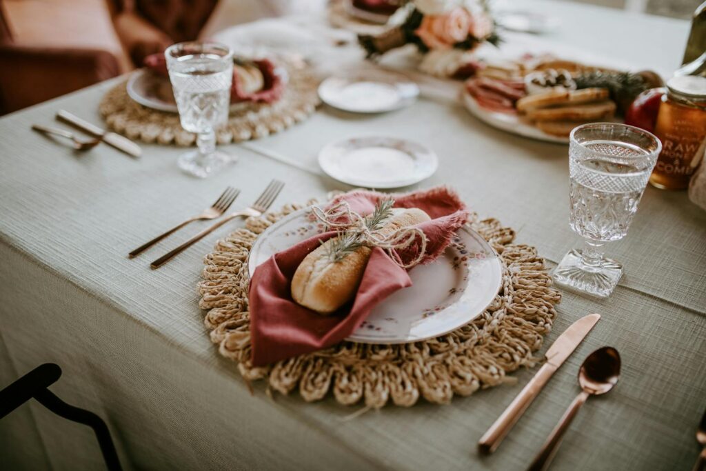 High angle of loaf tied with napkin and sprig of rosemary on served table at wedding celebration